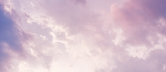 Wall Mural - Background of a beautiful pink and pale purple sky with clouds at sunset