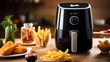Black air fryer or oil free fryer appliance on the wooden table with cement wall kitchen,