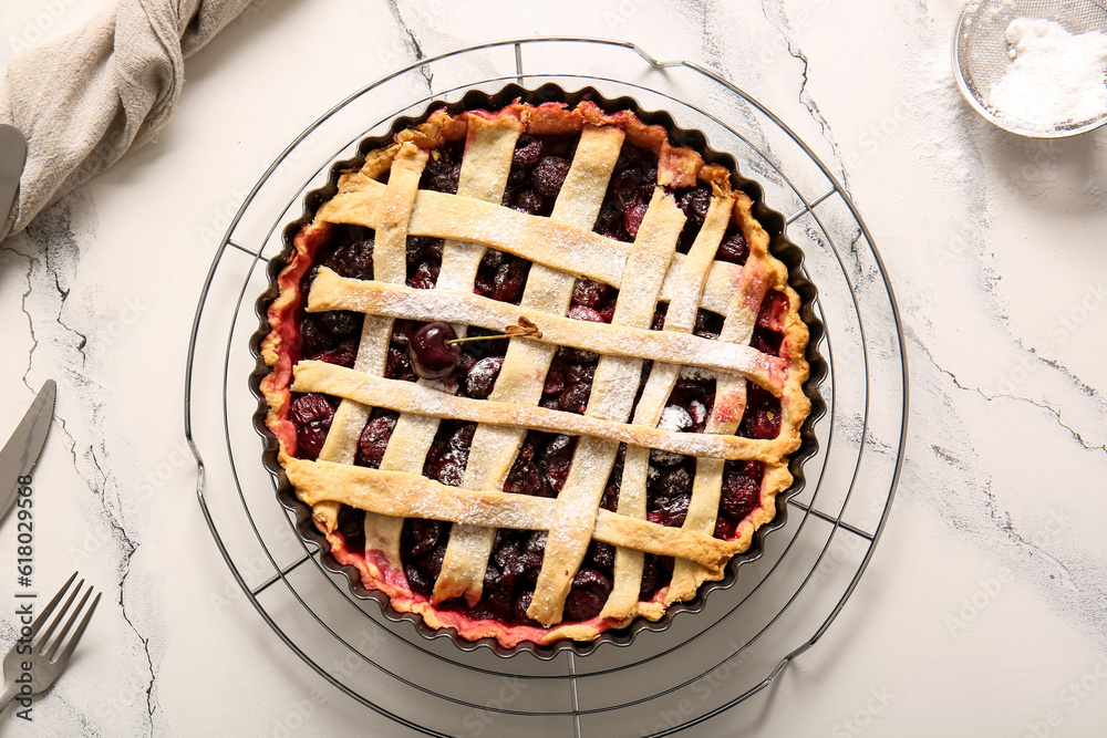 Baking dish with tasty cherry pie on white background