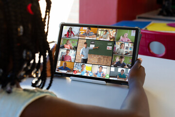 Poster - diverse schoolchildren with male teacher having tablet video call