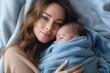 © YouraPechkin - Woman holding adorable baby wrapped in blue blanket. Generative AI