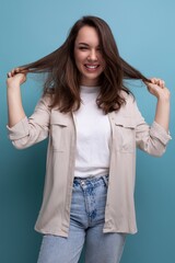 Canvas Print - positive cheerful young brunette female adult in casual shirt