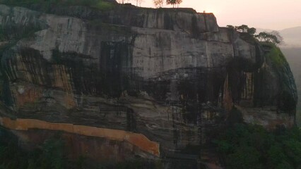 Wall Mural - Aerial of the Lion Rock or Sigiriya mountain in Sri Lanka surrounded by the dense green forest