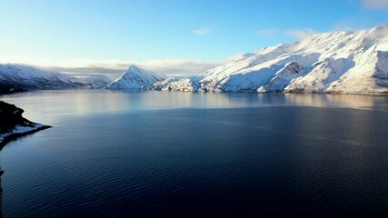 Sticker - Aerial video of the rocky sea shore covered with snow on a sunny day