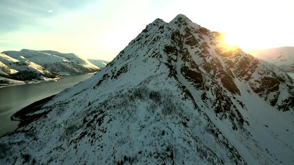 Sticker - Aerial video of the peak of the rocky snowy mountain with a river in the background