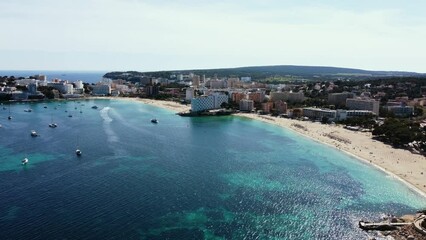 Wall Mural - Aerial footage of boats by the island and green hills on the horizon in Mallorca