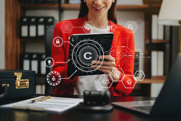 Wall Mural - Copyright or patent concept, Person hand using laptop computer, tablet and smartphone with virtual screen copyright icon trademark, Creation ownership against piracy. at office..