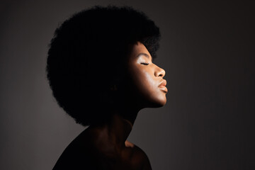 Wall Mural - Face shadow, light and black woman with skincare, natural beauty glow and peace after cosmetics treatment. Aesthetic makeup profile, afro and African studio person with self care on grey background