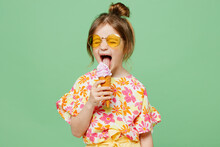 Little Cute Child Kid Girl 6-7 Years Old Wearing Casual Clothes Sunglasses Eat Icecream Have Fun Isolated On Plain Pastel Green Background Studio Portrait. Mother's Day Love Family Lifestyle Concept.