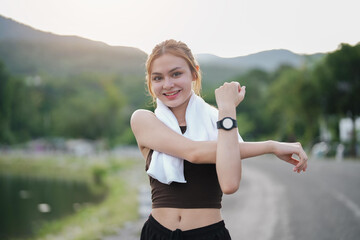 Young woman stretch during stretching exercise outdoors in the park