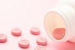 Female gender symbol on pink pills. Pills for women. Contraceptives or menopause