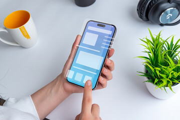 Poster - Woman holding a smartphone with a conceptual user interface. The interface showcases a clean design with vibrant colors and intuitive navigation elements