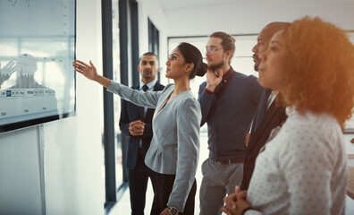 Data review, colleagues in a business meeting and planning in a boardroom of their workplace. Analytics or statistics, collaboration or teamwork and people in a office for strategy or presentation