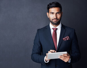 Portrait, businessman or tablet in studio, mockup space or background for trading, planning or research. Corporate trader, serious indian man in suit or digital technology of online stocks investment