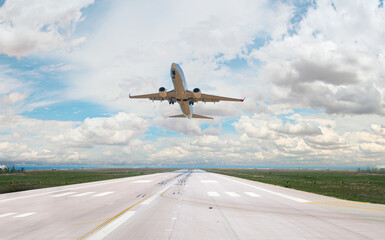 Wall Mural - White Passenger plane fly up over take-off runway from airport 