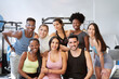 multicultural group of fitness people looking at camera and smiling at the gym