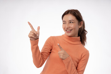 Portrait asian beautiful girl pointing blank space isolated background. Happy woman pointing on something. young female standing pointing finger sideways, billboard, introduction, advertisement