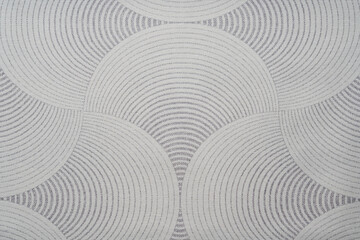 Light gray fabric texture with an abstract pattern.