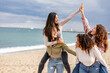 © PintoArt - happy multiracial women at party beach run together and have fun