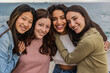 © PintoArt - portrait of four diverse female friends on the beach