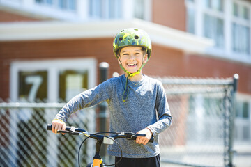 Wall Mural - child having fun outdoors driving bike for children on playground