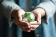 © ThePixelCraft - Green Earth Planet on Volunteer's Hands - World Environment Day Concept - Created with Generative AI Tools