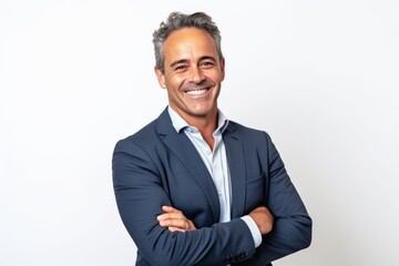 portrait of happy mature businessman with arms crossed standing against white background