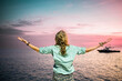 © Melinda Nagy - woman looking at pink sunset over tropical sea freedom