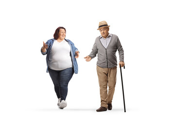 Wall Mural - Young overweight woman walking and talking to a senior gentleman