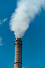 Poster - Pipe with dense smoke on blue sky background