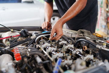 Wall Mural - Auto mechanic repair engine in a car repair shop and Checking a car engine for repair at car garage.Car engine repair. Car service