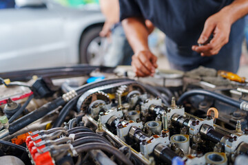 Wall Mural - Auto mechanic repair engine in a car repair shop and Checking a car engine for repair at car garage.Car engine repair. Car service