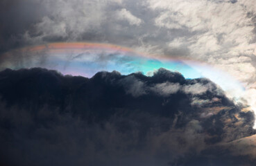 Wall Mural - Fire Rainbow in the sky with clouds and rainclouds as background