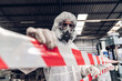 © kanpisut - Scientist wear Chemical protection suit check danger chemical, working at dangerous zone in Red and White Lines of barrier tape. Red and white Hazardous restricted area factory safety worker industry