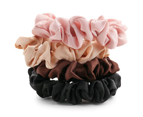 Set of stylish silk scrunchies on white background