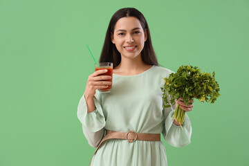 Canvas Print - Young woman with glass of vegetable juice and parsley on green background