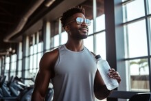 Energetic Fitness Black American Man Holding Reusable Water Bottle During Workout In Gym.