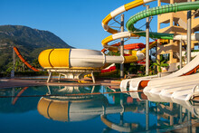 Empty Water Park For Kids In A Luxury Hotel Near The Sea. Water Park, Bright Multi-colored Slides With A Pool. A Water Park Without People On A Summer Day With A Beautiful, Cloudy Blue Sky. Aquapark 