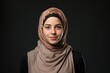 Headshot of a pretty middle eastern teenage girl posing looking at the camera wearing a hijab