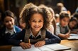 © sirisakboakaew - African american students doing exams in classroom at elementary school cute little boy sitting on the table Feeling excited and happy while learning with teachers in kindergarten.