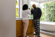© WavebreakMediaMicro - Happy biracial couple in pyjamas brushing teeth together in bathroom in the morning