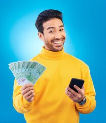 Poster - Cash, money and portrait of Asian man with phone in studio for online bonus, competition and lottery. Success, finance and male person on blue background excited for promotion, winning and deal