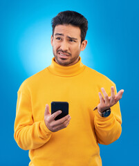 Poster - Scam, error and Asian man with a smartphone, confused and internet issue against a blue studio background. Male person, guy and model with a cellphone, doubt and decision with connection problems