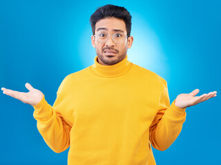 Aufkleber - Confused, shrug and portrait of a man in a studio with an unsure, doubt or question expression. Uncertain, choose and headshot of a male model with a decision gesture isolated by a blue background.