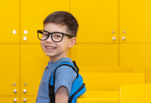 Back To School Happy Preschooler Boy Kid In Classroom Happy Smiling Face Or Bored Expression Sitting At Table.boy With Glasses Frame On Eyes Or Magnifying Glass.child Carrying Many Books,backpack