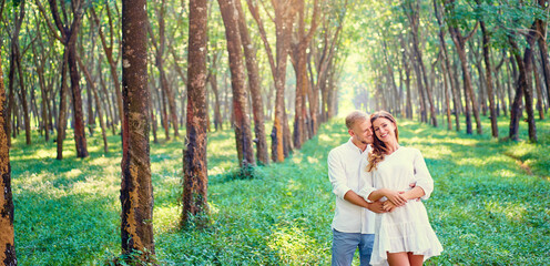 Love and tenderness. Beautiful young loving couple embracing in green garden. Romantic dating.