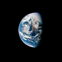 Planet Earth seen from space half-covered in sun light against a black background