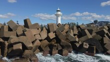 Landscape Of Waves Breaking Rocks Around Wollongong Breakwater Lighthouse In Australia