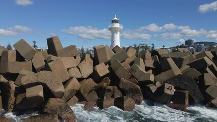Wall Mural - Landscape of waves breaking rocks around Wollongong Breakwater Lighthouse in Australia