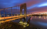 Aerial long exposure shot of the George Washington Bridge with car trails at sunset